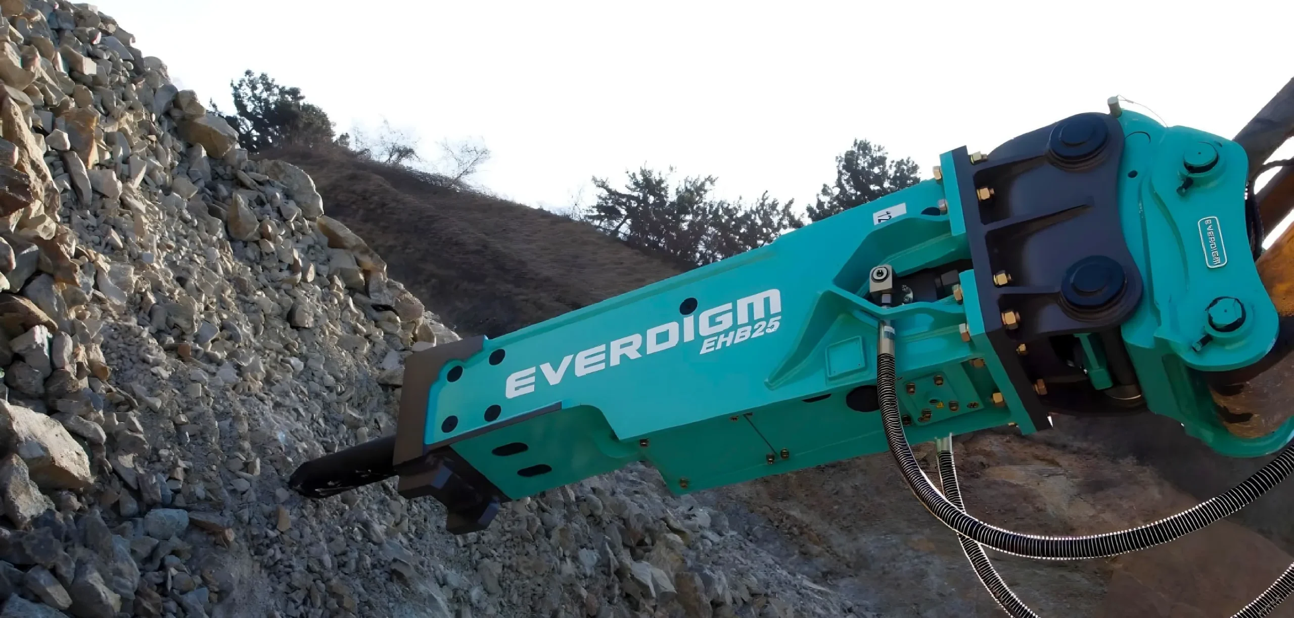 Develon excavator with Everdigm attachment working on rocky terrain, representing high-performance construction machinery in South Africa