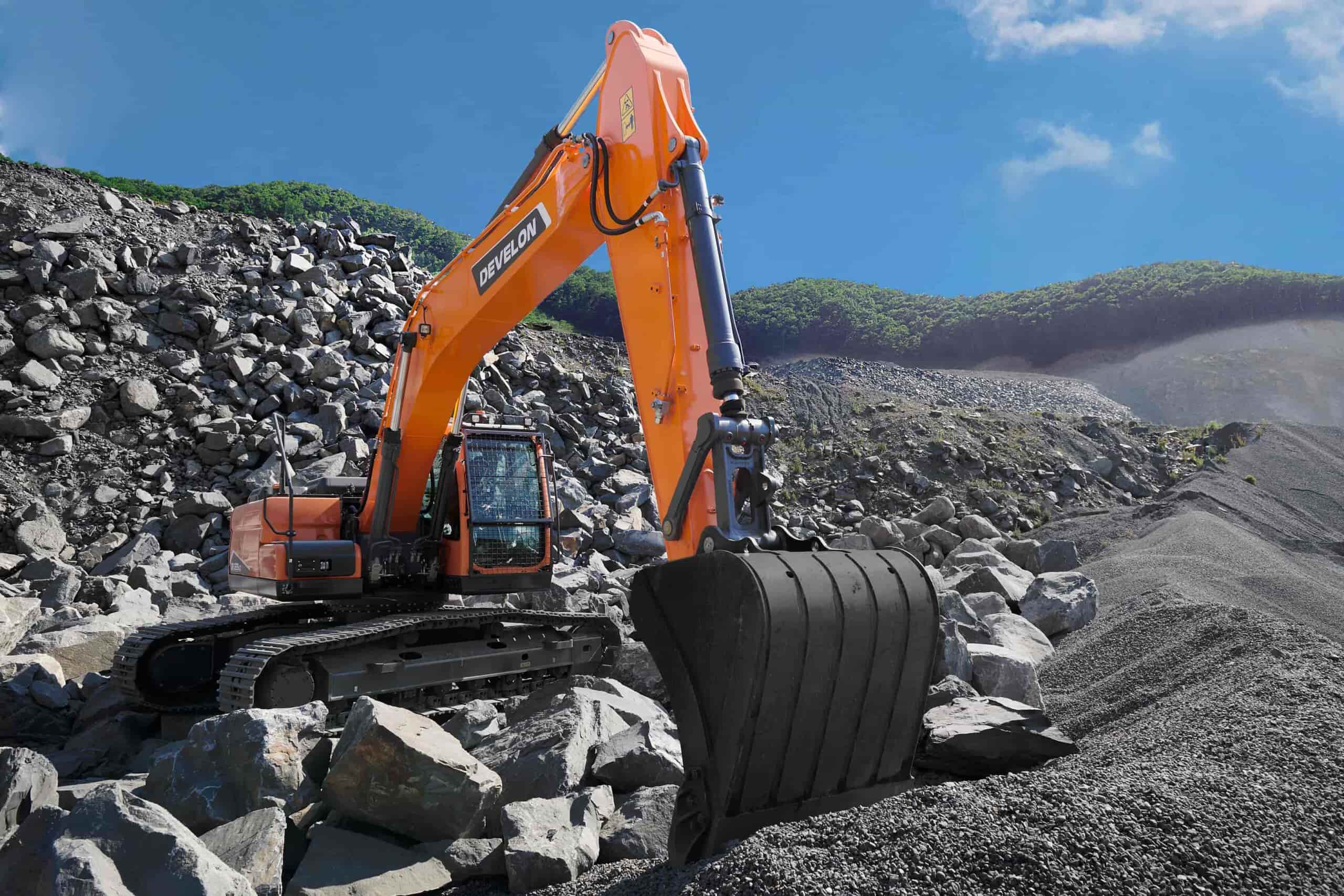 Develon excavator moving rocks in a quarry, showcasing the power and reliability offered by top construction machinery suppliers in South Africa